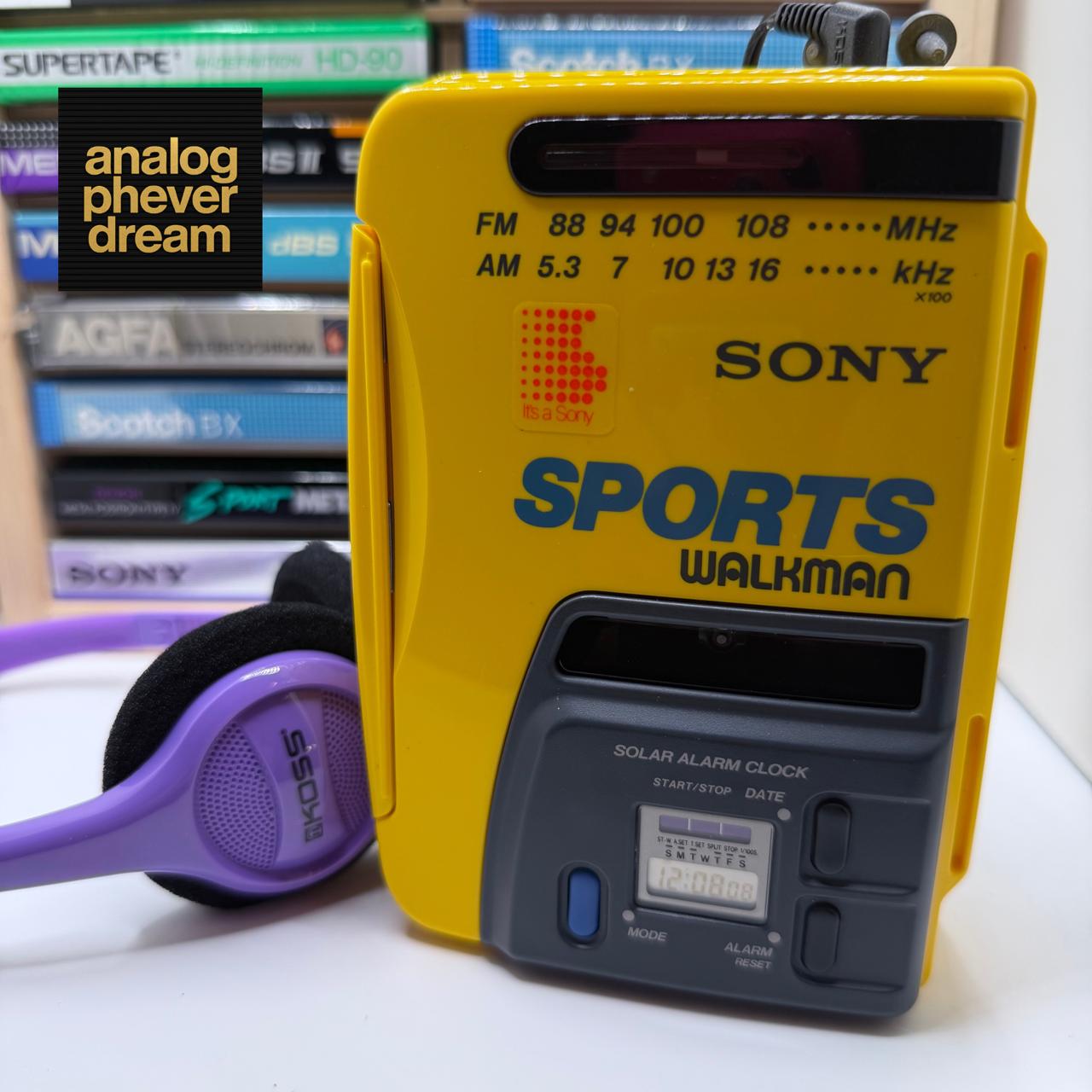 yellow SONY sports walkman with purple headphones